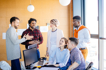 mixed race copywriters are enjoying spending time together at work