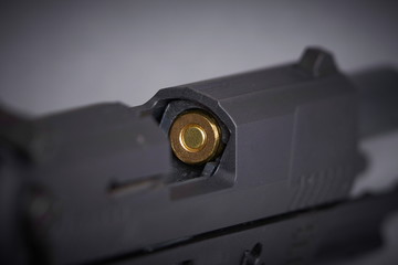 bullet in the chamber of a handgun