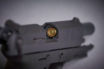bullet in the chamber of a handgun