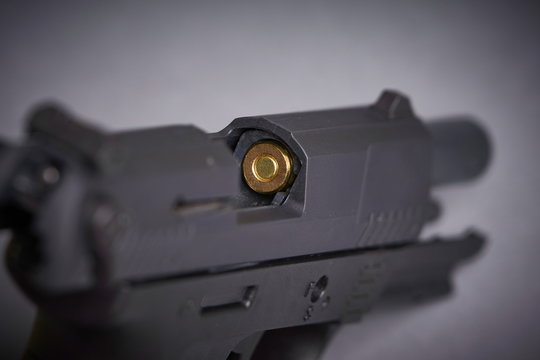 bullet in the chamber of a handgun