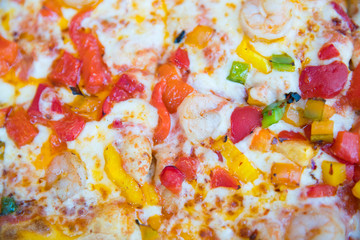 Slice of hot pizza large cheese lunch or dinner crust seafood meat topping sauce. with bell pepper vegetables delicious tasty fast food italian traditional 