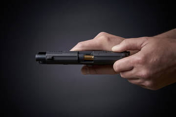 reloading a handgun, pulling back slide, top view