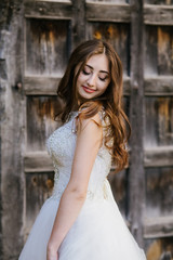 Fototapeta premium bride in wedding dress, beautiful brunette woman in national park near medieval castle, portret,
