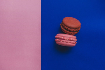 French Colorful pink and brown Macarons flatlay. Colorful Pastel Macarons on a pink and blue Background. Color Schemes. free spot for text