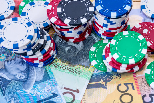 Colourful casino chips on australian dollars closeup