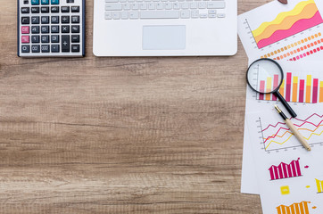 Finance analyst working place with magnifying glass