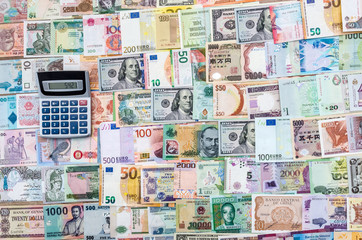 Fototapeta na wymiar Close up of calculator on banknote collection