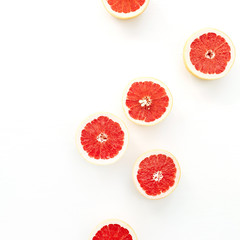 Sliced grapefruits on white background. Flat lay, top view.