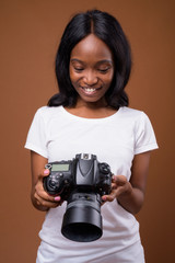 Young beautiful African Zulu woman against brown background