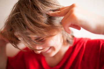 Boy teenager holds his head with his hands