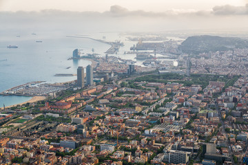 Fototapeta premium Aerial view of Barcelona city with port and harbor at sunset, Spain.