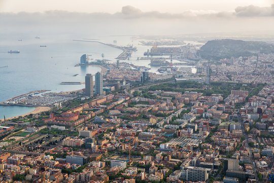 Aerial view of Barcelona city with port and harbor at sunset, Spain.