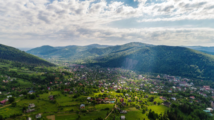 Obraz premium Aerial view of Carpathian mountains in summer. Village in the mountains.