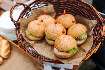 Hot fresh burgers in a wicker basket.