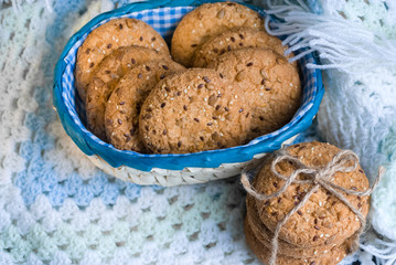 Savory cookies sprinkled with sesame seeds, sunflower on textile plaid