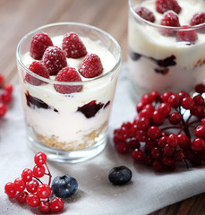 yogurt with muesli and berries on a wooden table