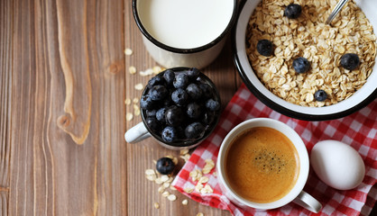 A healthy breakfast - Oatmeal porridge, boiled egg, milk, fresh berries and coffee. A great start to a new day.