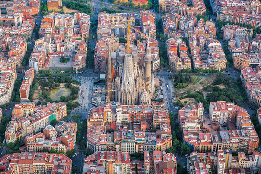 Aerial view of Barcelona Eixample district with park and Sagrada familia, Spain. Sunset light