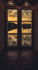 Clouds reflected in the lake at sunset. View through the window