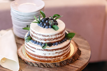 Obraz na płótnie Canvas Wedding or birthday cake with berries. Sweet pie on banquet in restaurant.