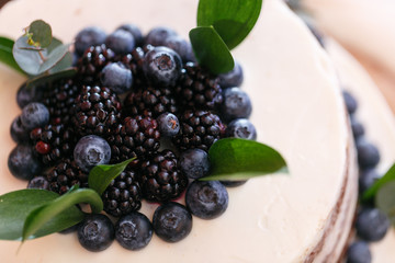 Wedding or birthday cake with berries. Sweet pie on banquet in restaurant.