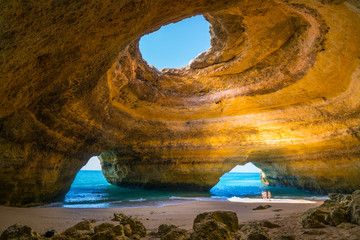 Carvoeiro, Portugal - June, 10, 2015 - Tourists enjoy a beautiful day to know the Benagil Cave in Algarve, one of the most wonderful caves in the world. - obrazy, fototapety, plakaty