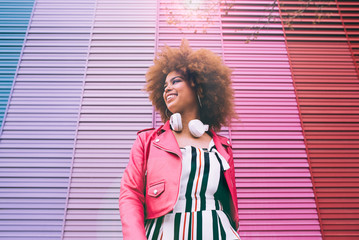 Mixed race woman in a multicolor wall background