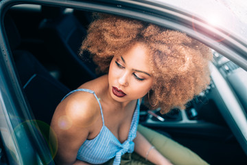 Fototapeta na wymiar Mixed race woman sitting in a car