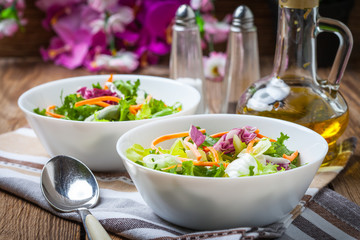 Mixed salad in white bowl.