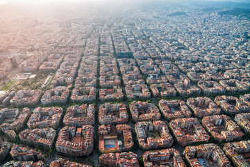 Fototapeta premium Aerial view of Barcelona cityscape with typical urban grid, Spain. Light leak effect applied