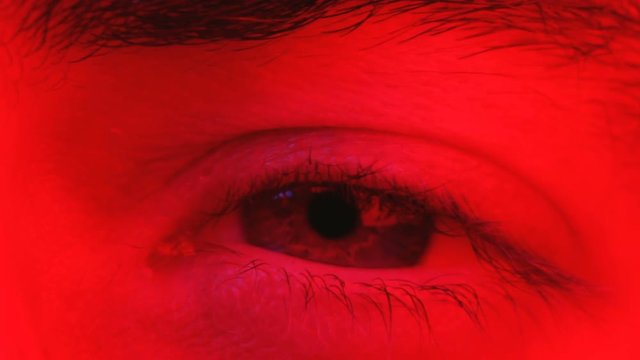 Macro on man eye expressing serious and expressionless expression