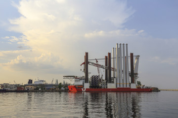 Pillars of the offshore windmill loaded on the ship in the habrour