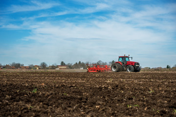 Fototapeta premium Tractor plowing fields.