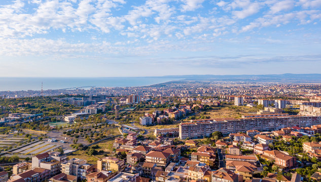 Beautiful aerial view on the Catania city with Etna volcano on the background by the sea. Small houses and beautiful narrow streets of Sicily.