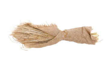 Fototapeta na wymiar A bouquet of rye ears wrapped in sackcloth isolated on white background.