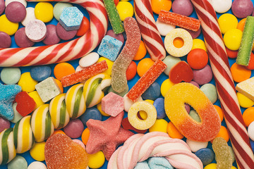 Fototapeta na wymiar Multicolored candy and lollipops on a white background.