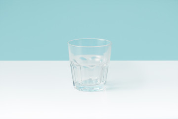 closeup view of water in glass on blue background