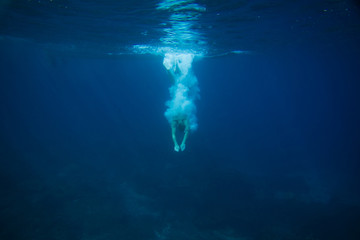 partial view of man diving into ocean - Powered by Adobe
