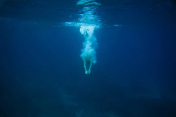 Fotobehang partial view of man diving into ocean © LIGHTFIELD STUDIOS