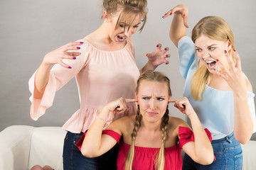 Woman being bullied by two females