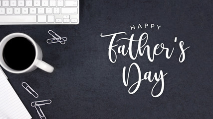 Happy Father's Day Text with Coffee, Keyboard and Notepad Over Black Desk Background