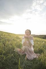 Dressed woman on dandelion field