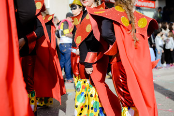 Blurry street carnival party parade unrecognisable people dressed for joyful fun, outdoors background