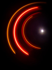 Music concept. Freezelight glowing vinyl on dark background or Turntable playing vinyl with glowing abstract lines concept on dark background.