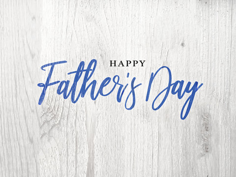 Happy Father's Day Blue Calligraphy Script Over White Wood Texture Background