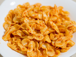 pasta in white plate with tomato sauce