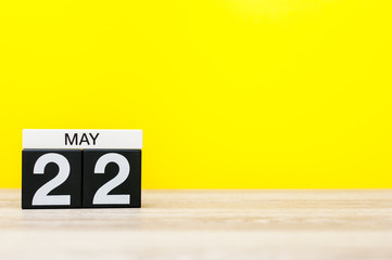 May 22nd. Day 22 of may month, calendar on yellow background. Spring time, empty space for text