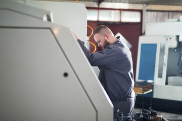 Man working on CNC machine