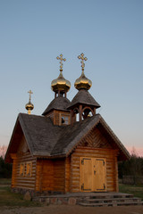Fototapeta na wymiar old wooden traditional church with golden kross