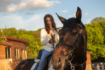 Fototapeta premium beautiful girl is riding a horse